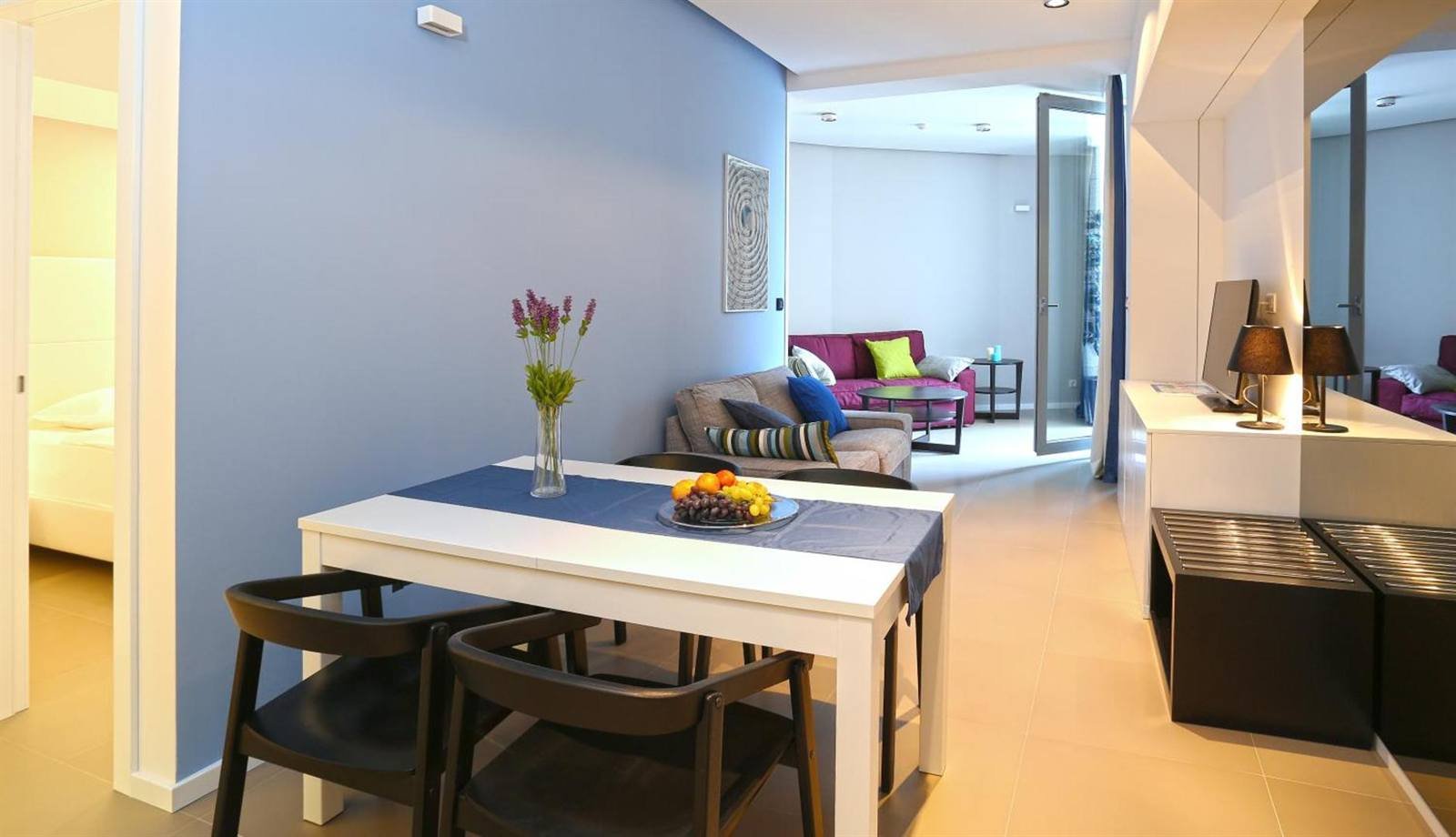 Apartment dining table with fruit and the living area behind